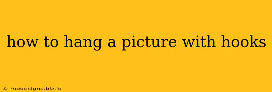 how to hang a picture with hooks