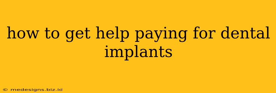 how to get help paying for dental implants